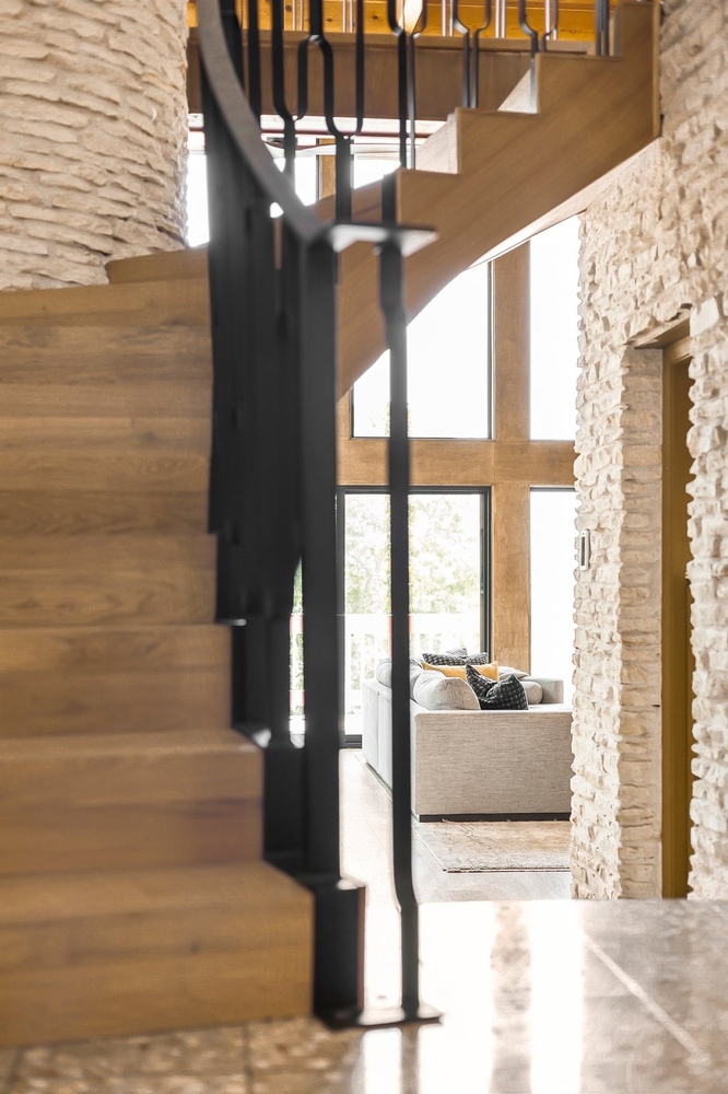 staircase remodel with wood steps and black metal railing by RedOven Builds Austin TX