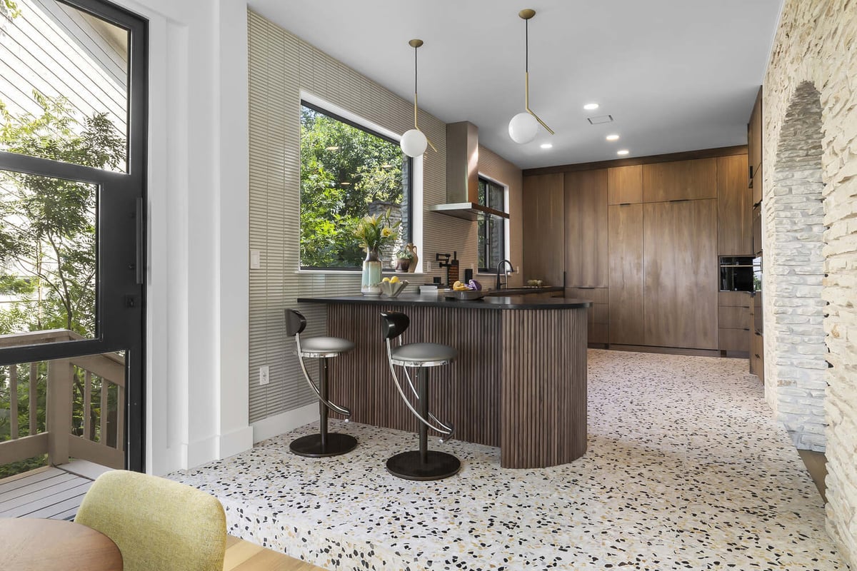 updated kitchen with wood cabinetry and integrated appliances by RedOven Builds Austin TX