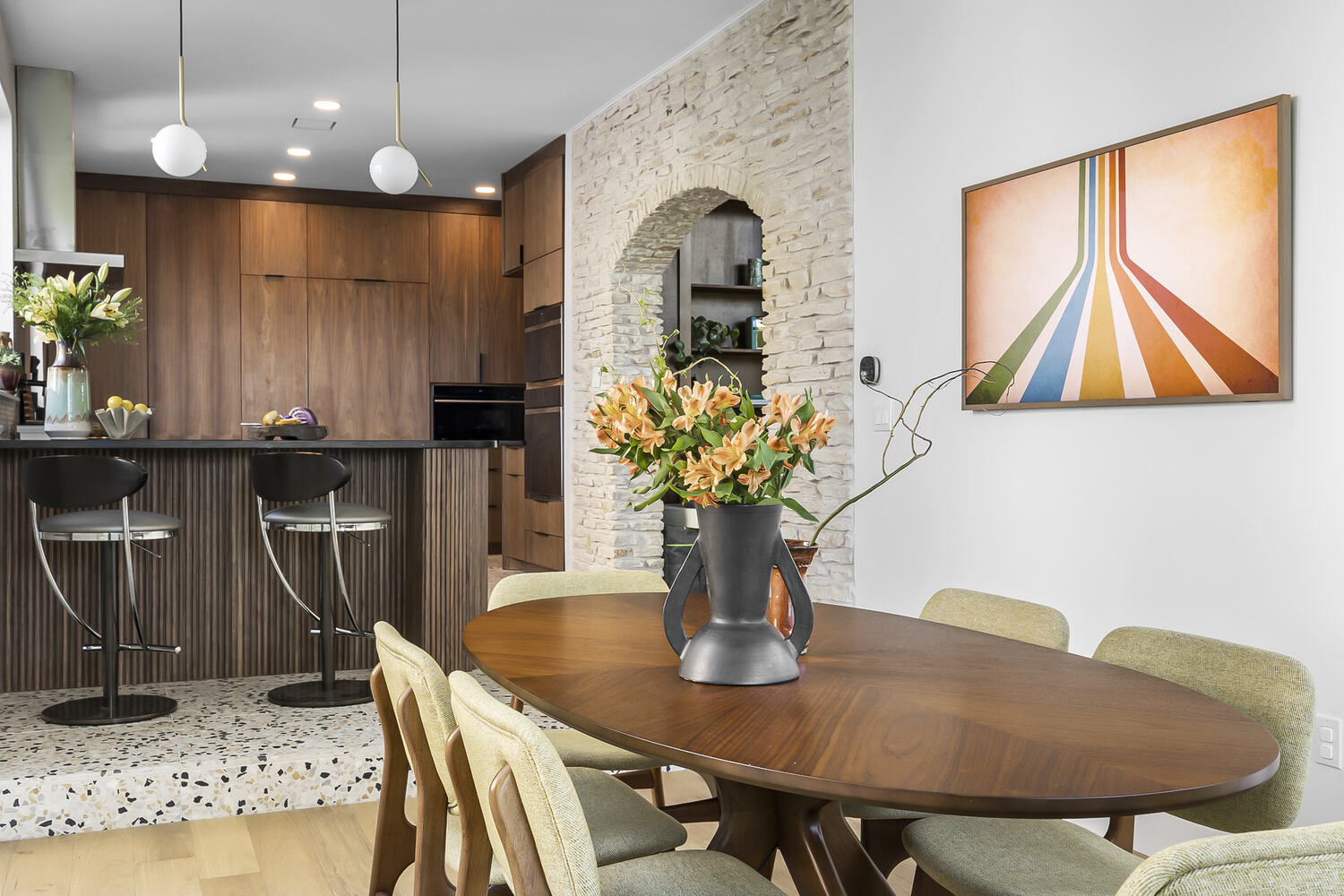updated kitchen with wood cabinets and bar seating in Austin TX full home remodel by RedOven Builds