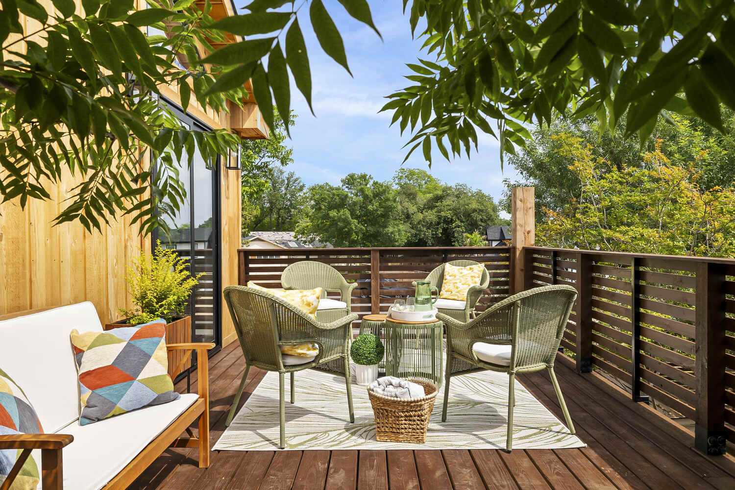 ADU deck seating area with wicker chairs and decorative accents by RedOven Builds in Austin TX
