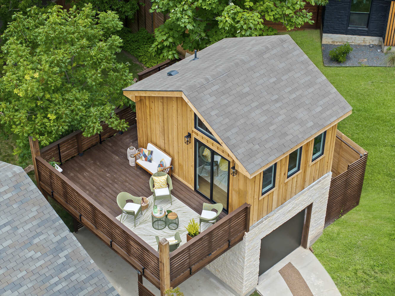 Aerial view of custom ADU with elevated deck and garage by RedOven Builds in Austin, TX