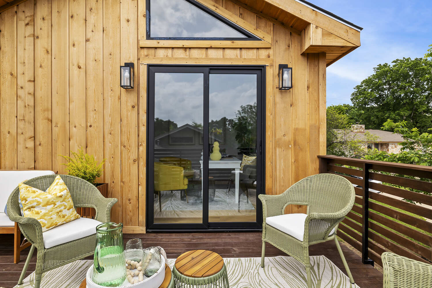 Close-up of modern sliding glass doors and deck seating on a RedOven Builds ADU in Austin, TX
