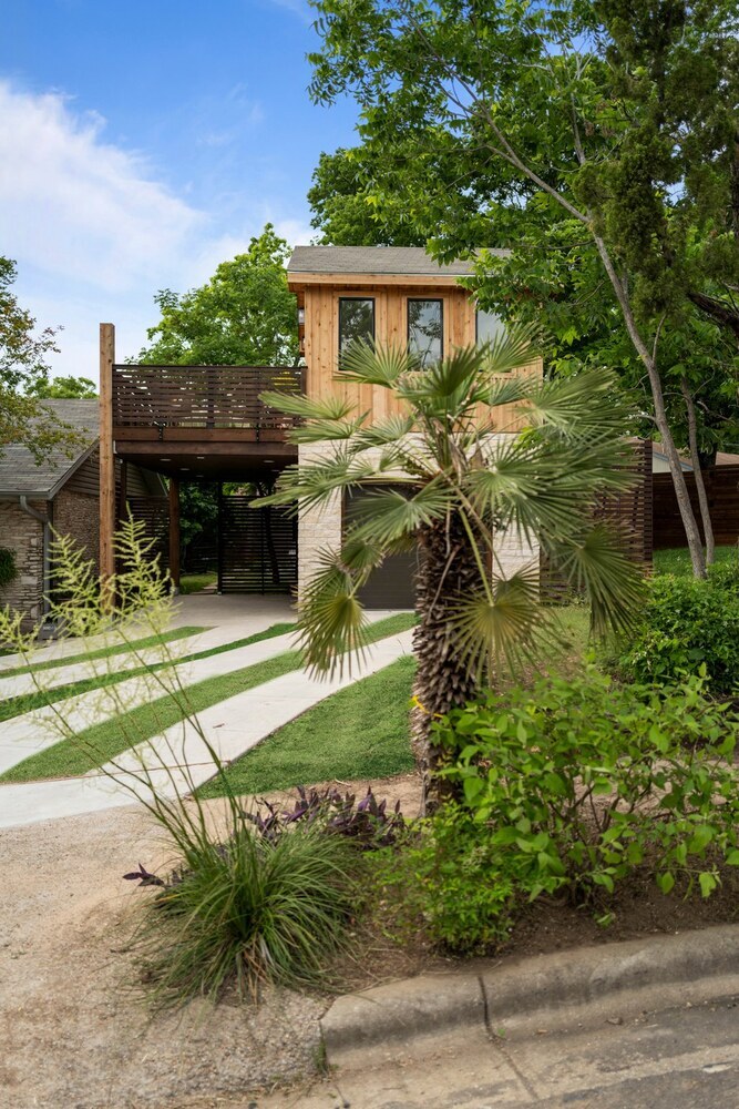 Custom-built ADU exterior with wood siding and landscaped yard by RedOven Builds in Austin, TX
