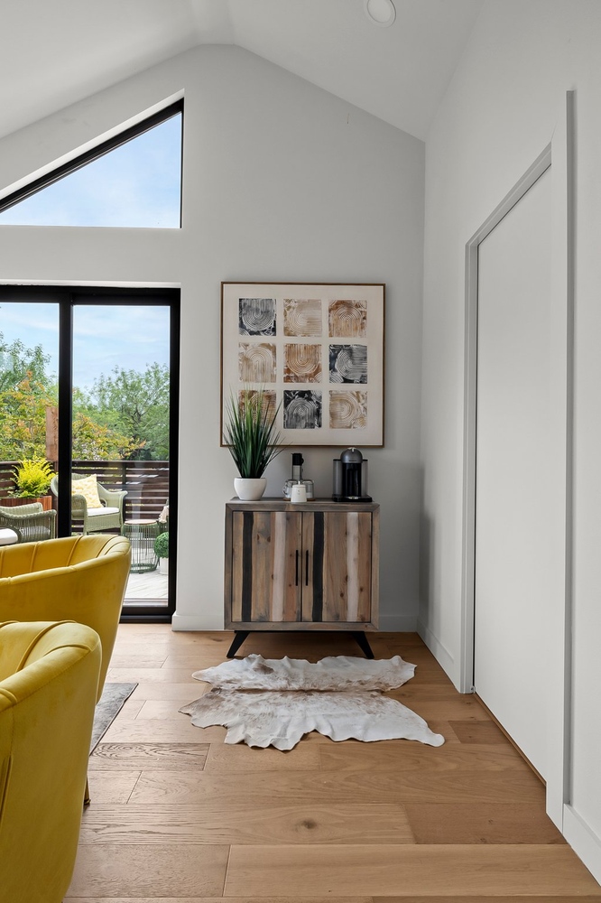 Interior ADU living space with sliding glass door and modern decor by RedOven Builds in Austin, TX