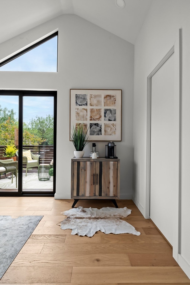 Interior ADU room with sliding glass door, cabinet, and modern styling by RedOven Builds in Austin, TX
