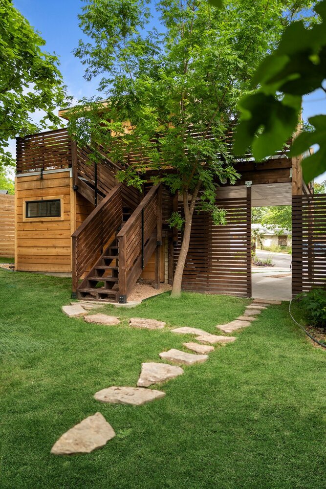 Modern ADU design with exterior stairs and privacy screen by RedOven Builds in Austin, TX