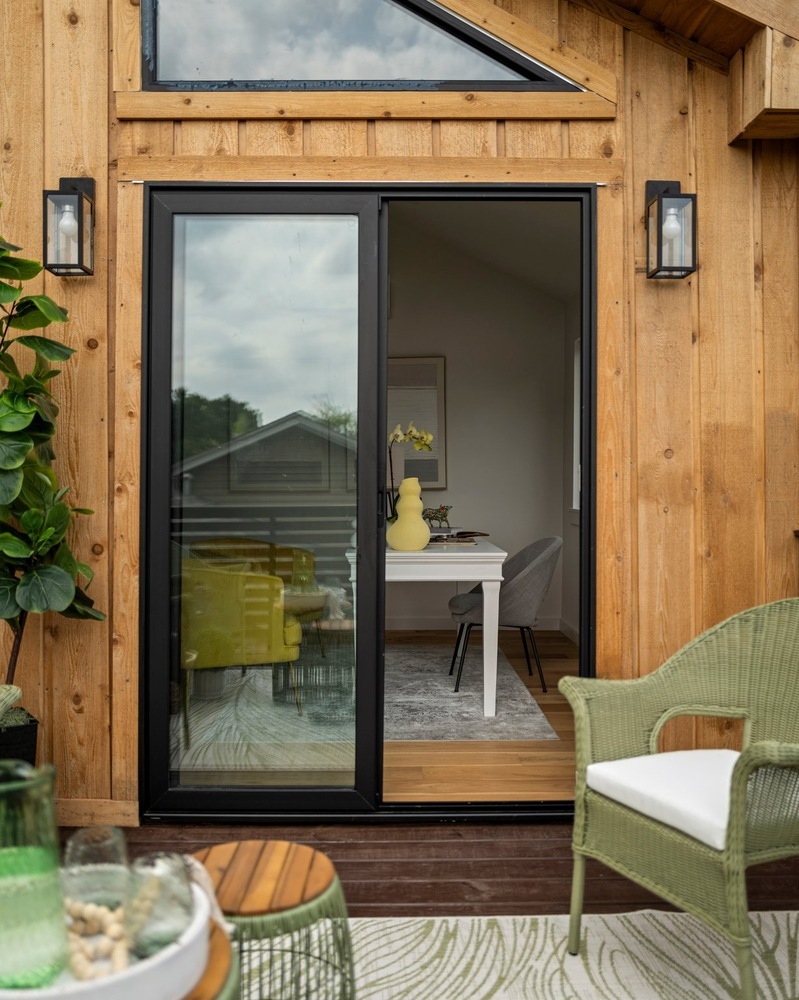 RedOven Builds ADU sliding glass door opening to deck and interior workspace in Austin, TX