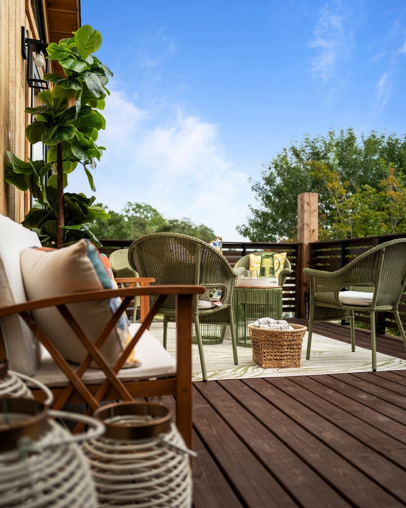 Stylish ADU balcony seating with plants and decor by RedOven Builds in Austin, TX