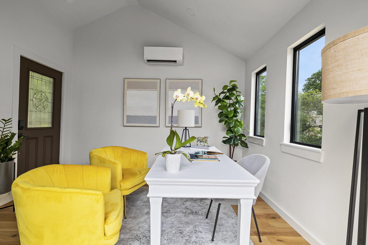 bright ADU office with yellow accent chairs and modern desk by RedOven Builds in Austin TX