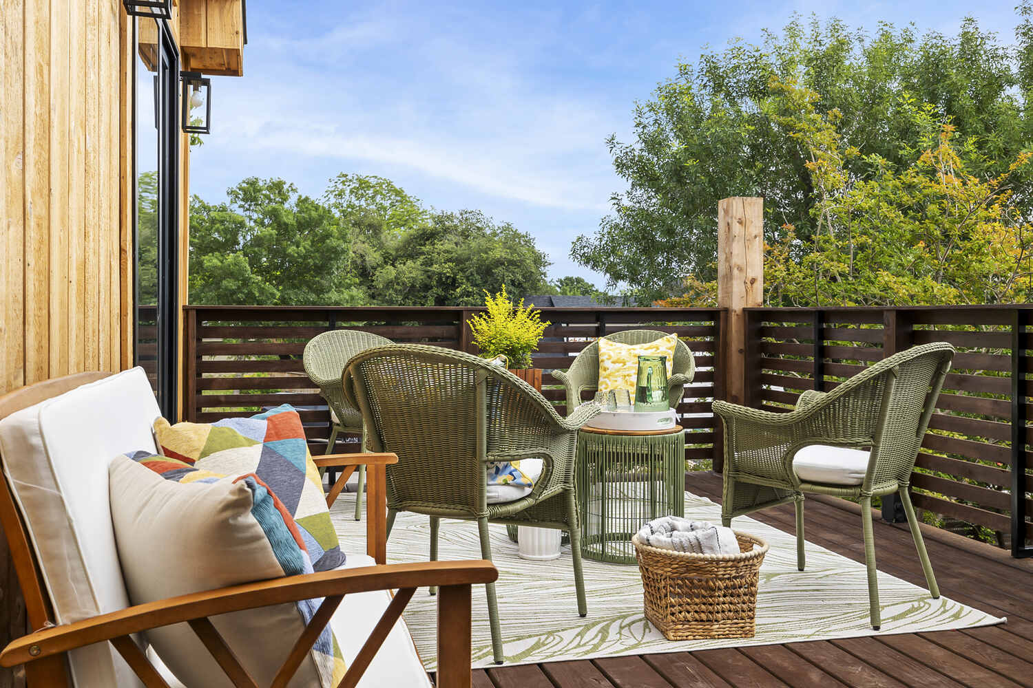 modern ADU deck with wicker seating and outdoor rug by RedOven Builds in Austin TX