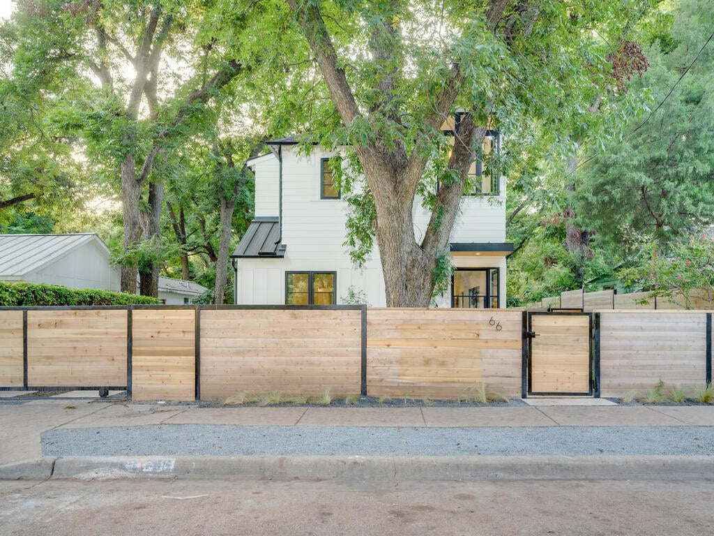 Modern home exterior behind privacy fence by RedOven Builds in Austin, TX