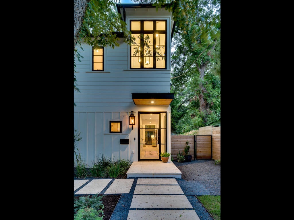 Modern new construction facade with vertical windows by RedOven Builds in Austin, TX