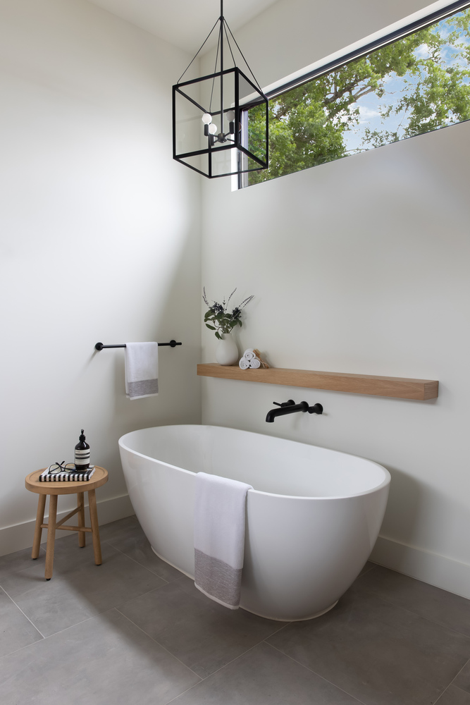 Contemporary bathroom with soaking tub and minimalist design by RedOven Builds in Austin, TX