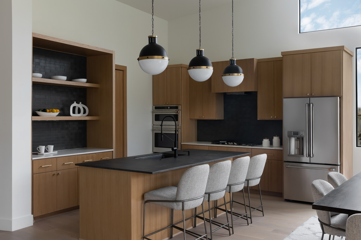 Custom home kitchen with open layout and bar seating by RedOven Builds in Austin, TX