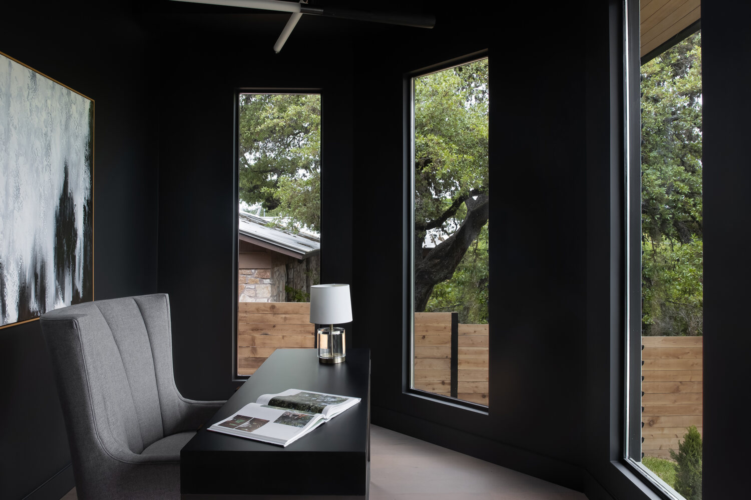 RedOven Builds modern office nook with black walls and large windows in Austin, TX