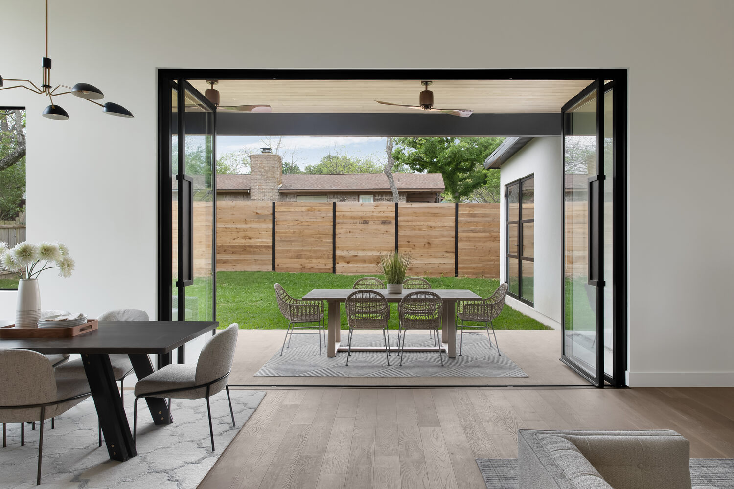 RedOven Builds open concept indoor-outdoor living with fully opened glass doors in Austin, TX