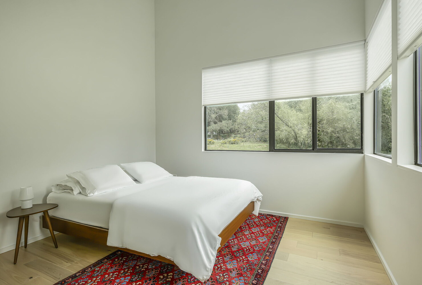 Clean-lined bedroom with large windows and natural views in RedOven Builds custom build Rio Grande, TX