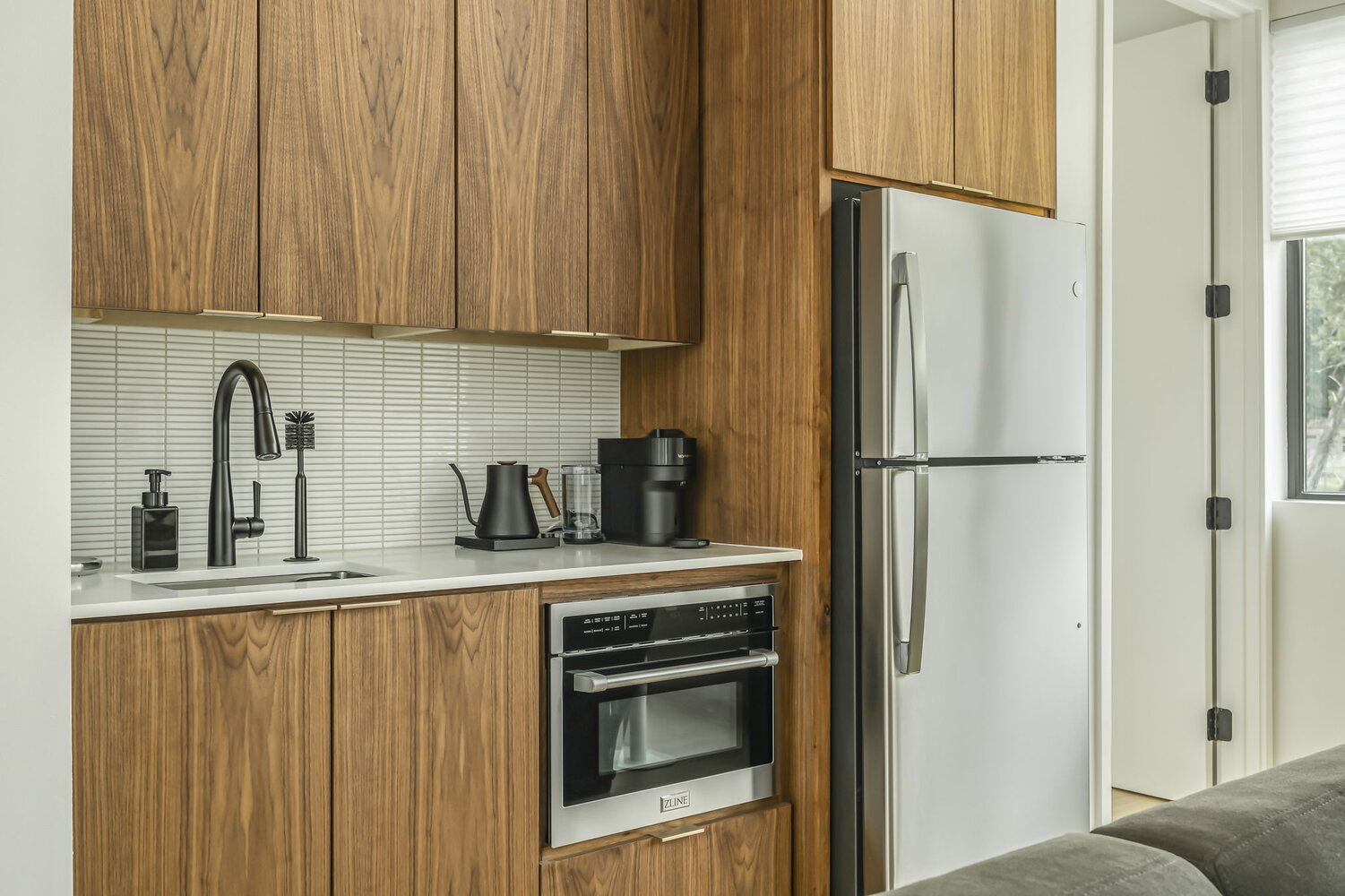 Close-up of custom kitchen cabinetry and appliances in RedOven Builds new home Rio Grande, TX