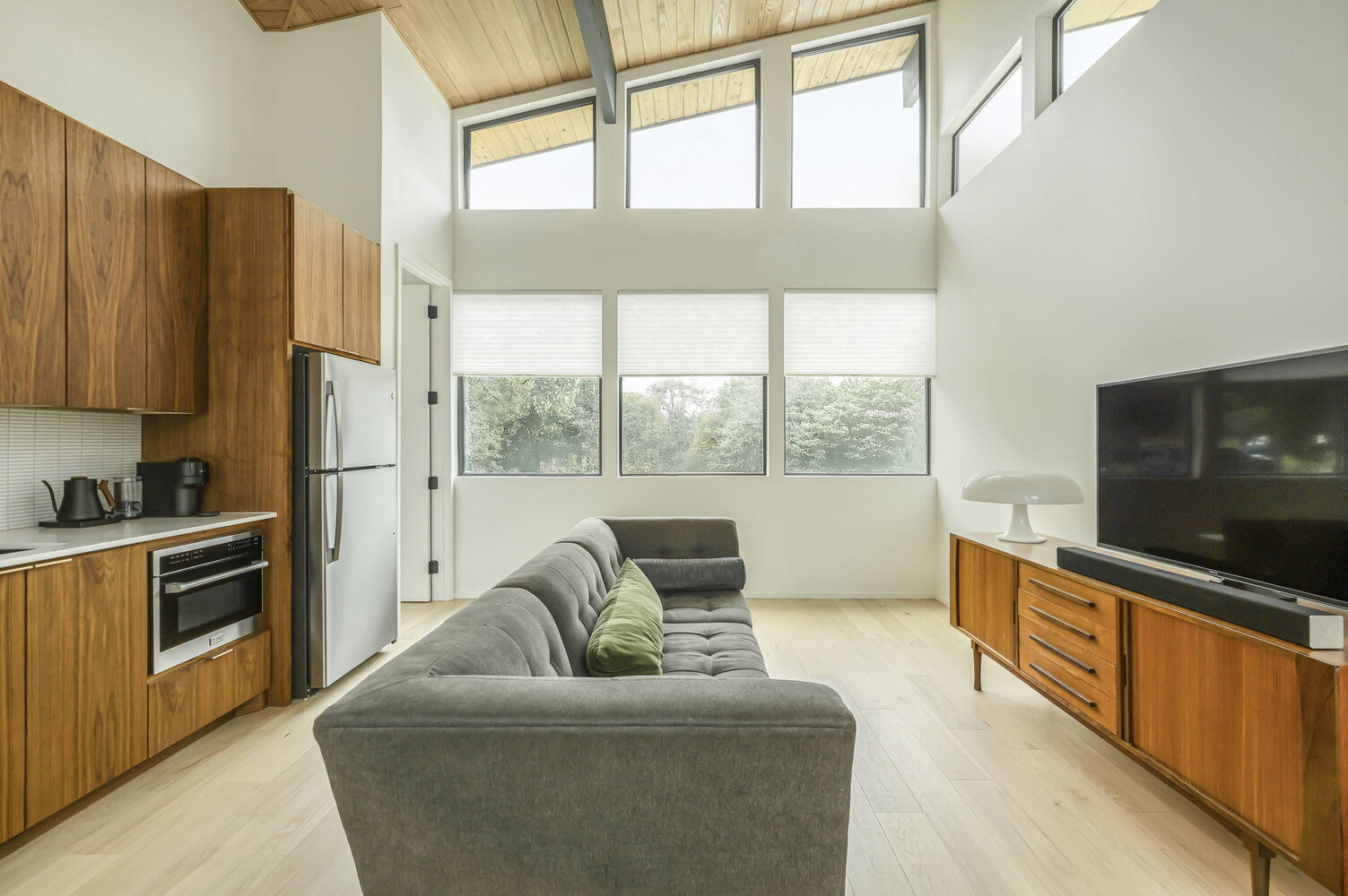 Open living space with modern kitchen and large windows in a RedOven Builds custom home Rio Grande, TX