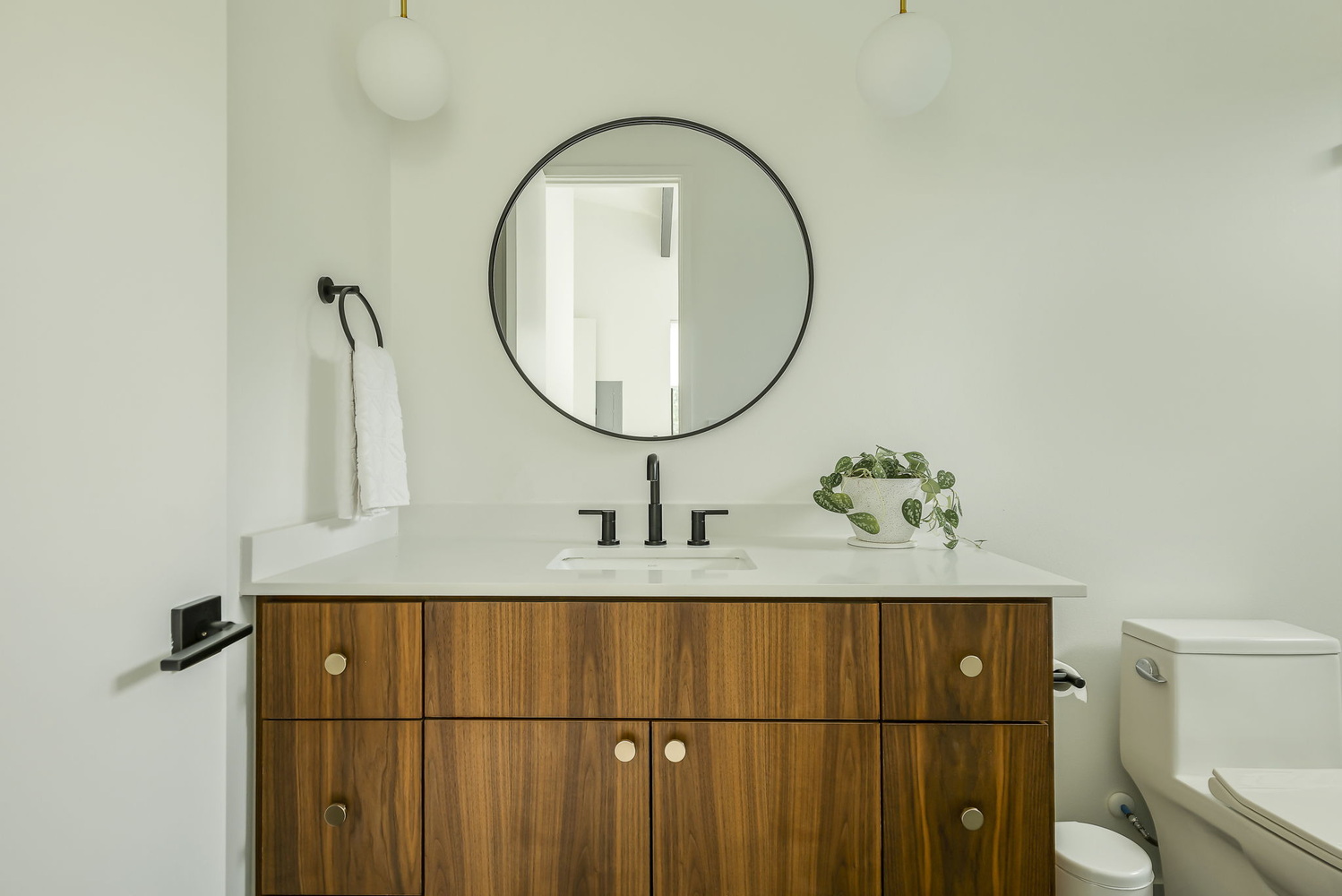Sleek bathroom with custom vanity and contemporary fixtures in RedOven Builds new build Rio Grande, TX