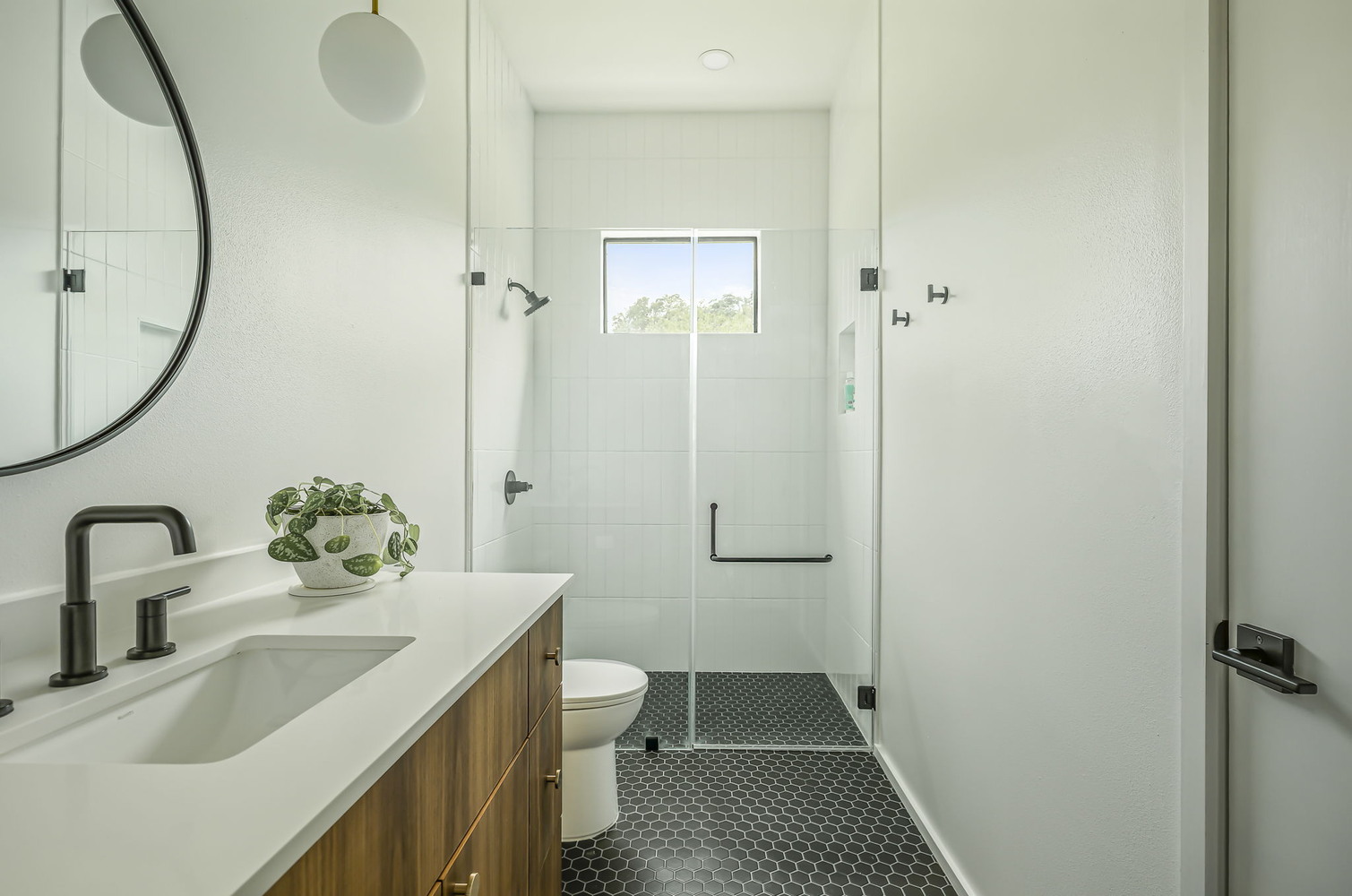 Stylish bathroom featuring glass enclosure and modern vanity in RedOven Builds Rio Grande, TX