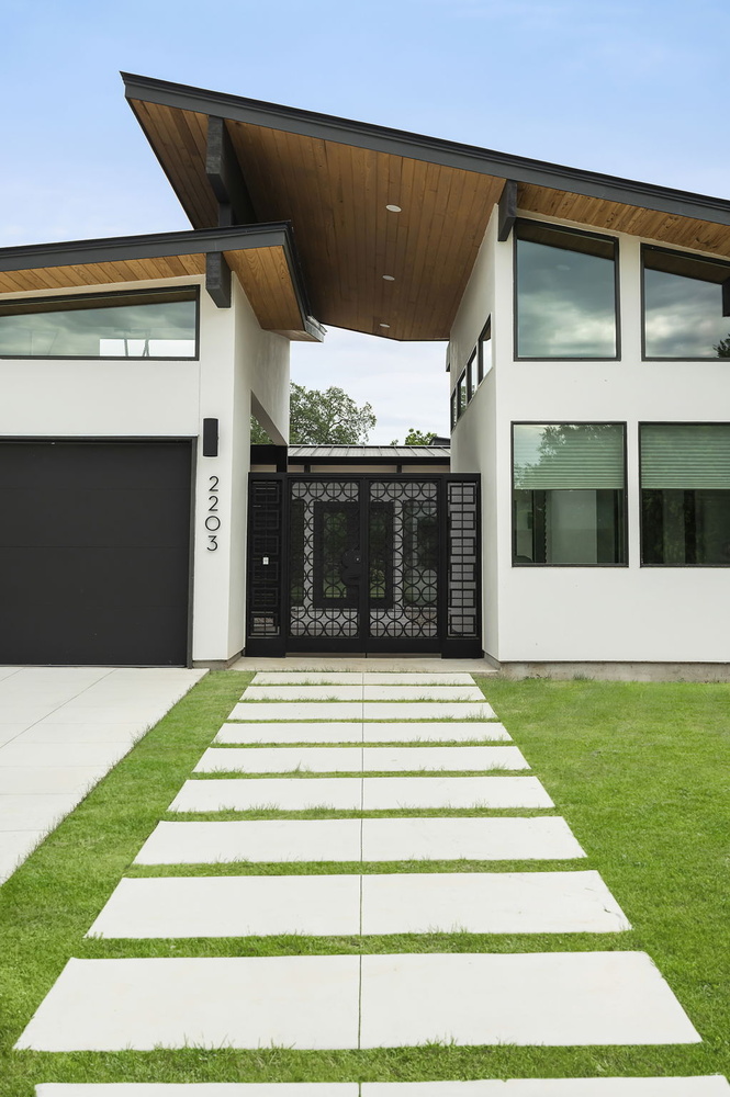 angled roof modern custom home entry and walkway by RedOven Builds in San Juan Dr Rio Grande TX