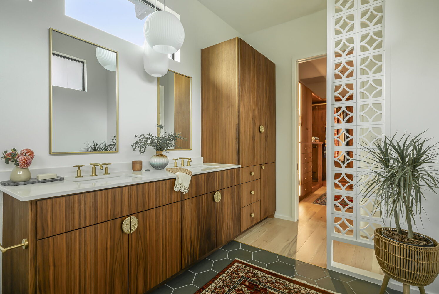 bathroom vanity and storage cabinetry with decorative divider in custom home by RedOven Builds Rio Grande TX