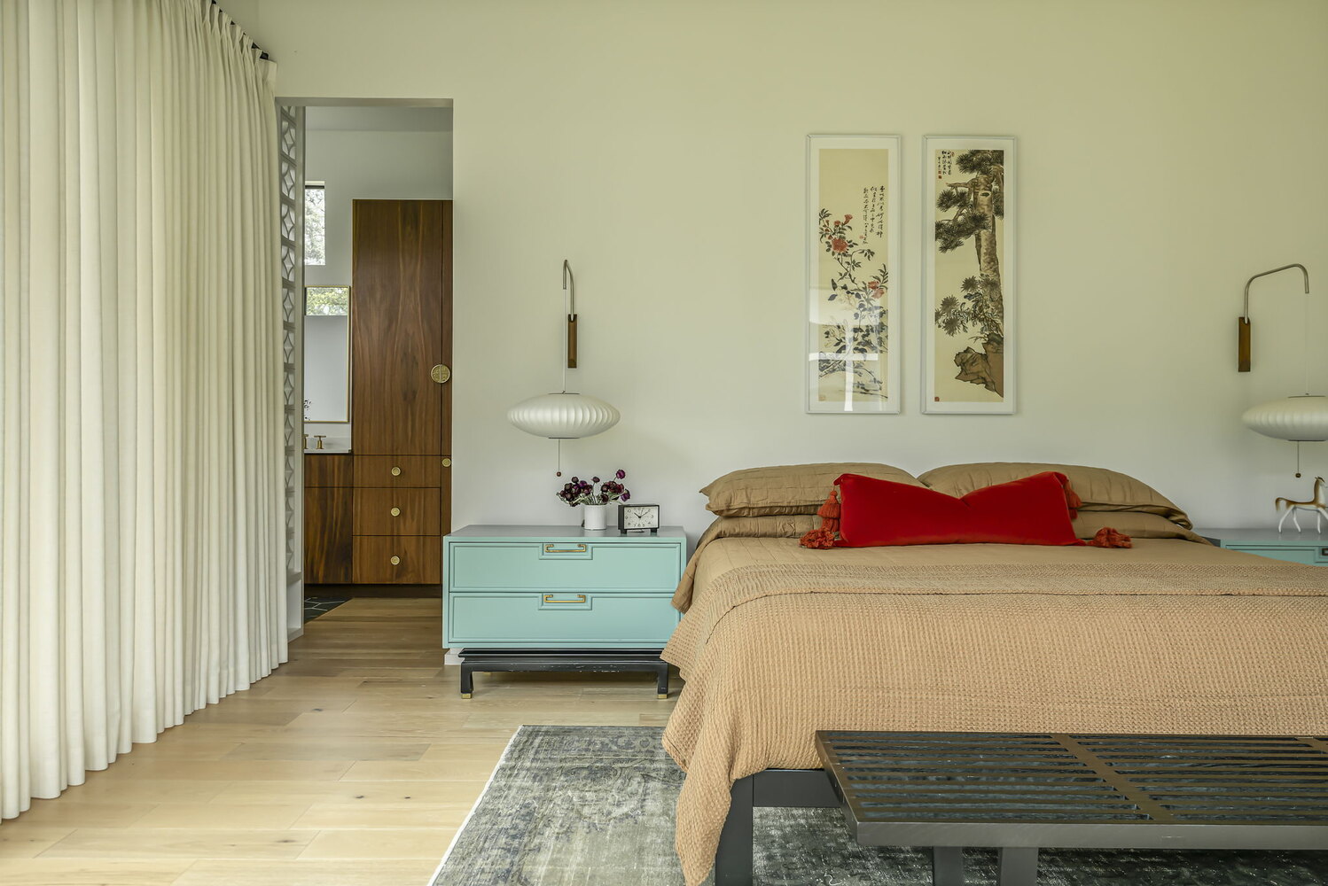 bedroom view with modern furnishings and bathroom entry in custom home by RedOven Builds Rio Grande TX