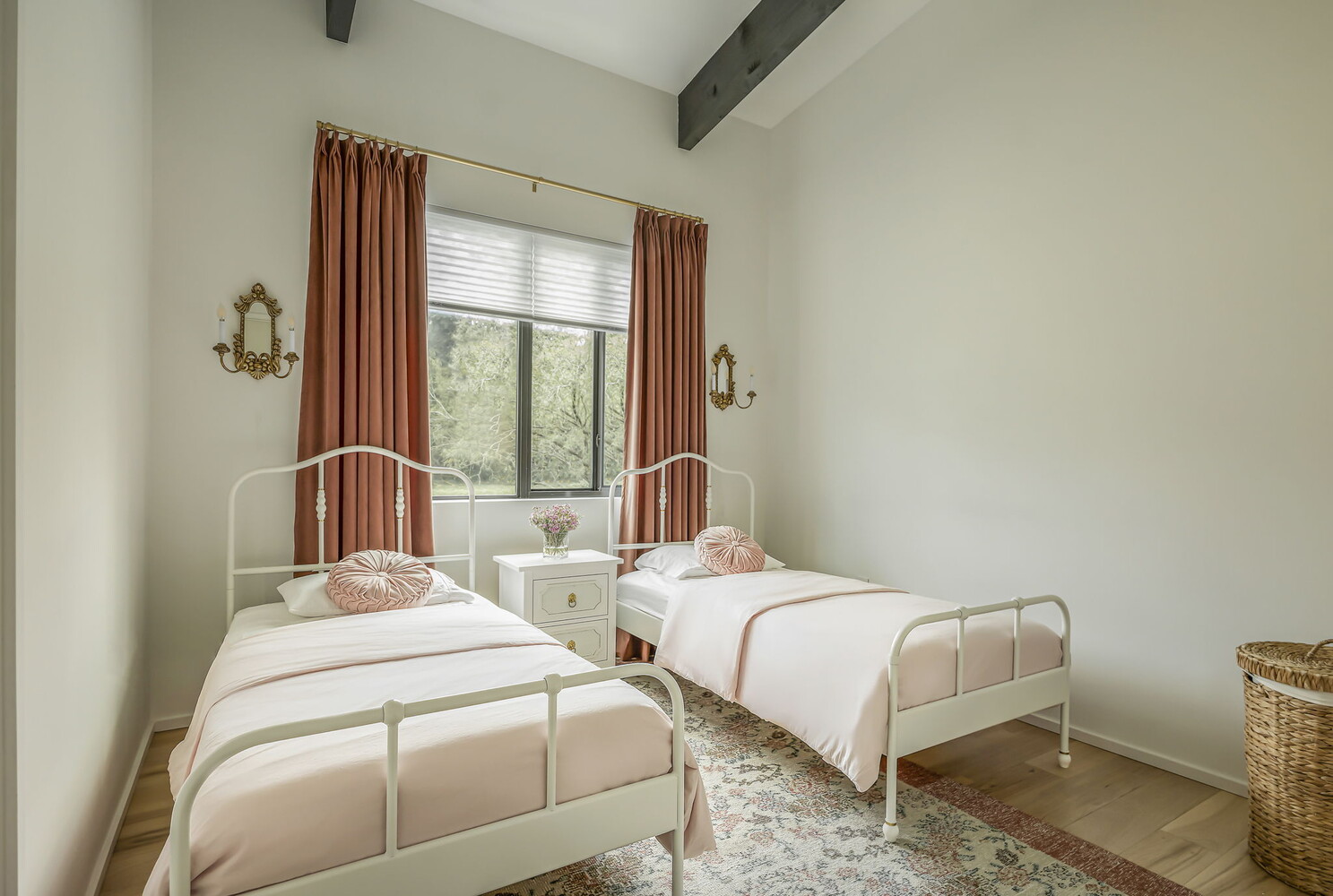 bright bedroom interior in RedOven Builds custom home featuring matching twin beds and large window in San Juan Dr Rio Grande TX