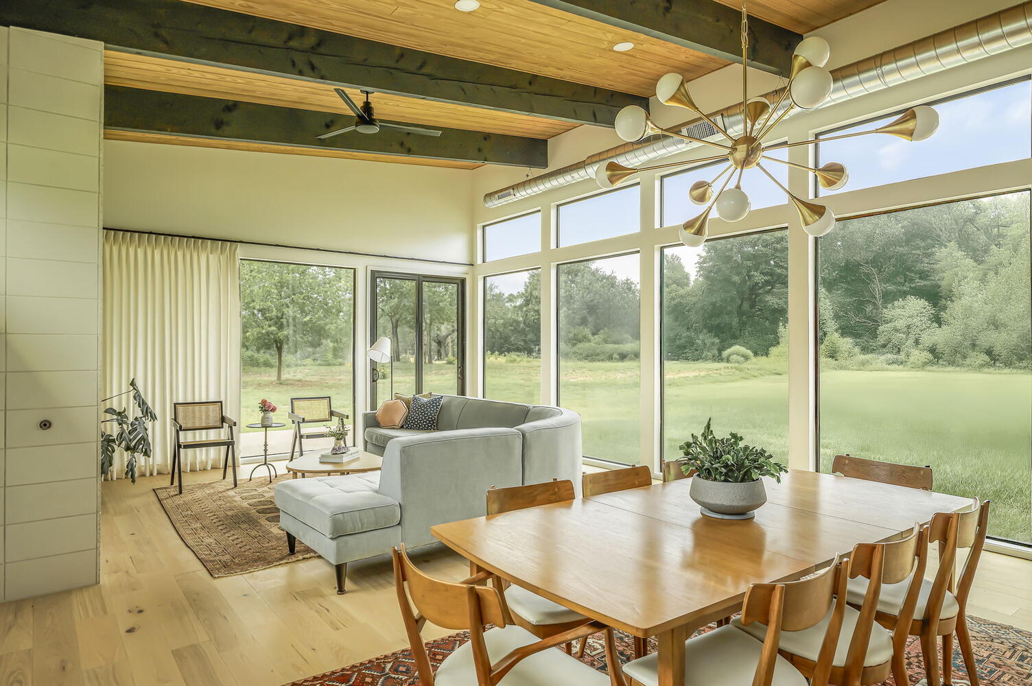 bright open living and dining room with large windows by RedOven Builds San Juan Dr Rio Grande TX