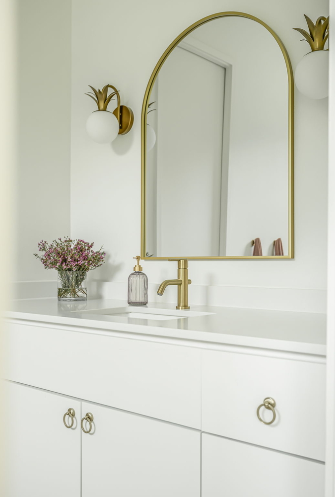close-up of luxury bathroom finishes by RedOven Builds featuring gold hardware and white cabinetry in San Juan Dr Rio Grande TX