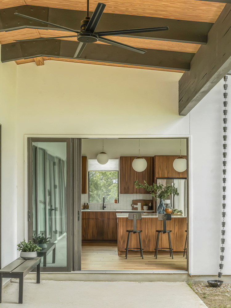 covered patio looking into custom kitchen with island by RedOven Builds in San Juan Dr Rio Grande TX