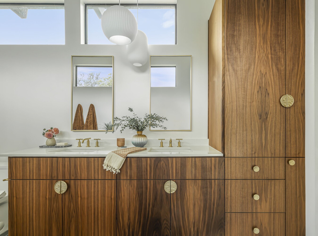 double sink vanity with walnut cabinets and brass fixtures in custom bathroom by RedOven Builds Rio Grande TX