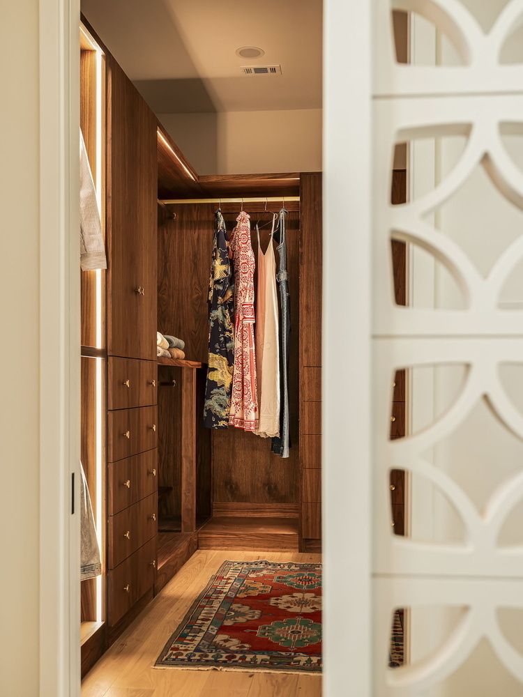 luxury closet entrance with built-in wood storage and lighting by RedOven Builds in Rio Grande TX