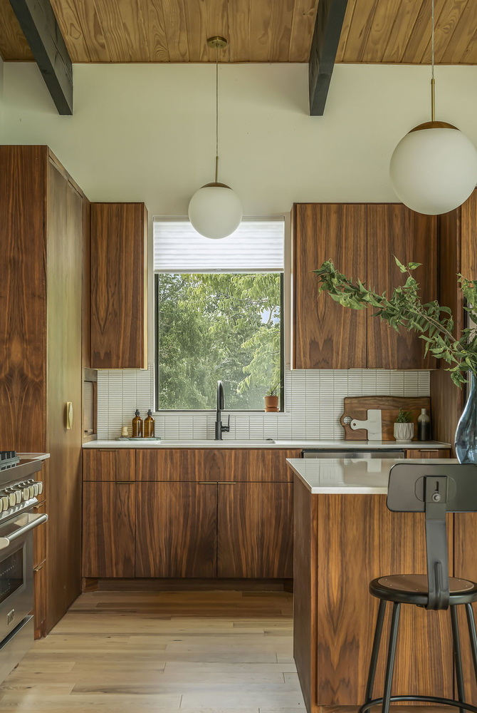 minimalist kitchen design with walnut cabinets and natural light by RedOven Builds San Juan Dr Rio Grande TX