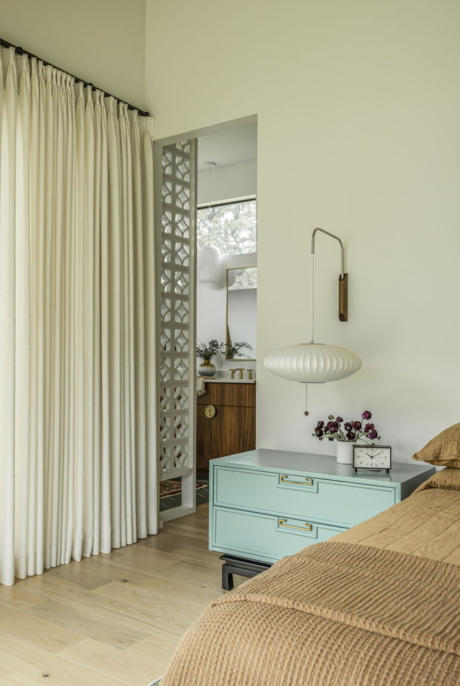 modern bedroom interior from RedOven Builds featuring soft drapery and mid-century style furniture in San Juan Dr Rio Grande TX