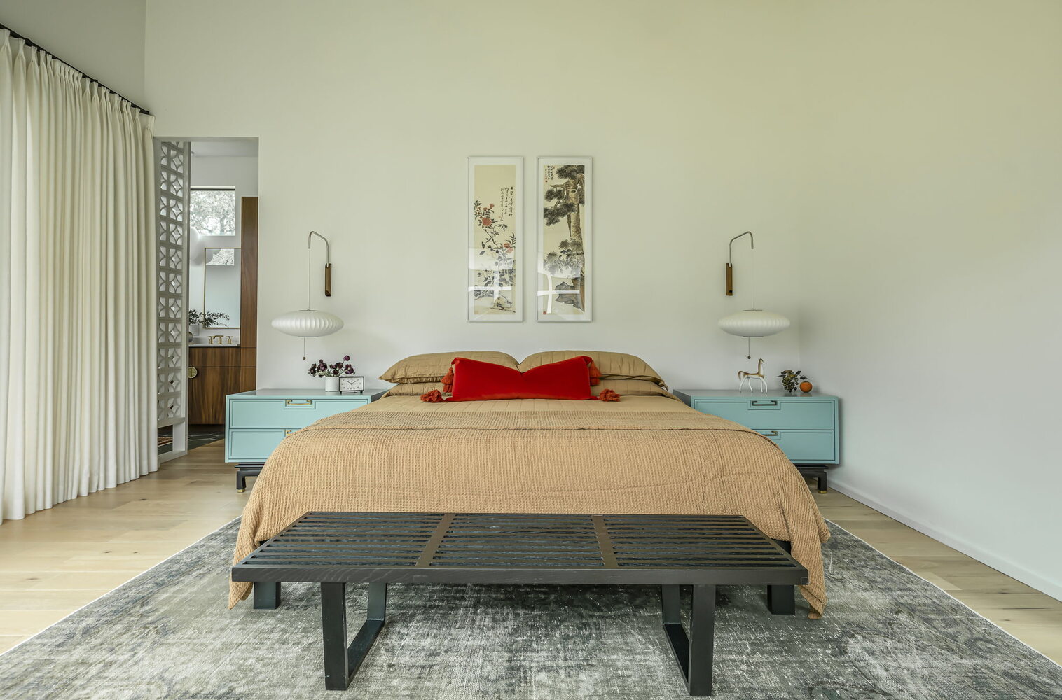 modern bedroom with king bed, accent pillows, and bedside tables in custom home by RedOven Builds Rio Grande TX