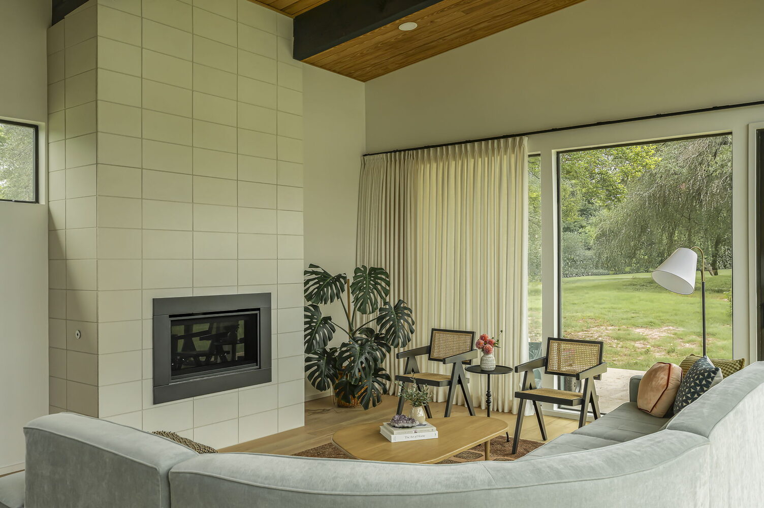 modern living room with tiled fireplace and large windows in custom home by RedOven Builds in San Juan Dr Rio Grande TX