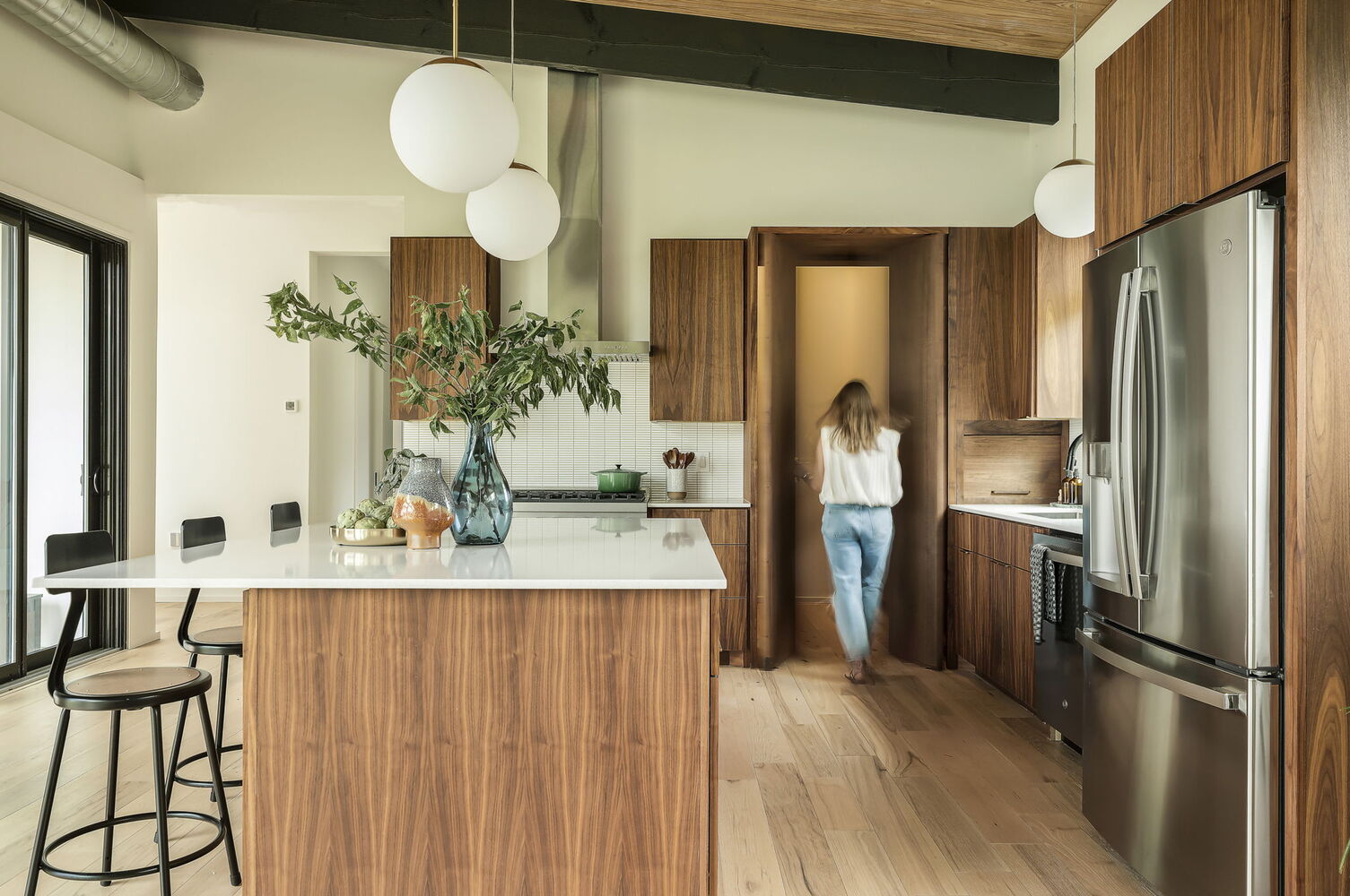 ontemporary kitchen with walnut cabinetry and hidden pantry by RedOven Builds San Juan Dr Rio Grande TX