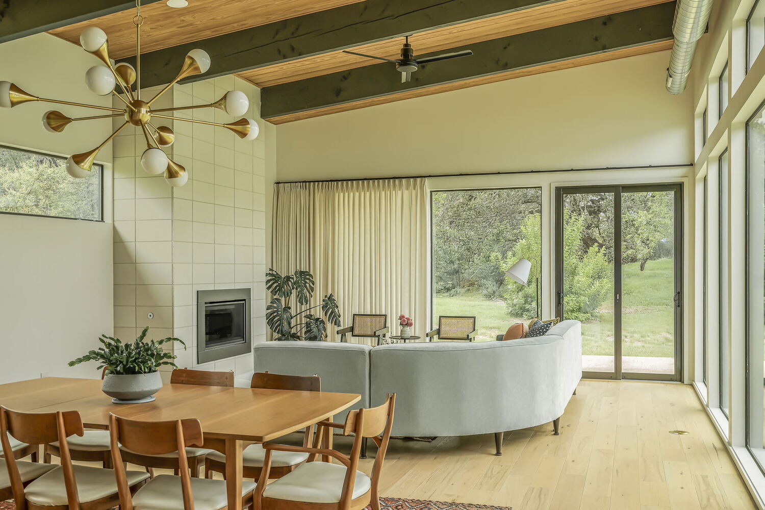 open living and dining area with fireplace and large windows by RedOven Builds San Juan Dr Rio Grande TX