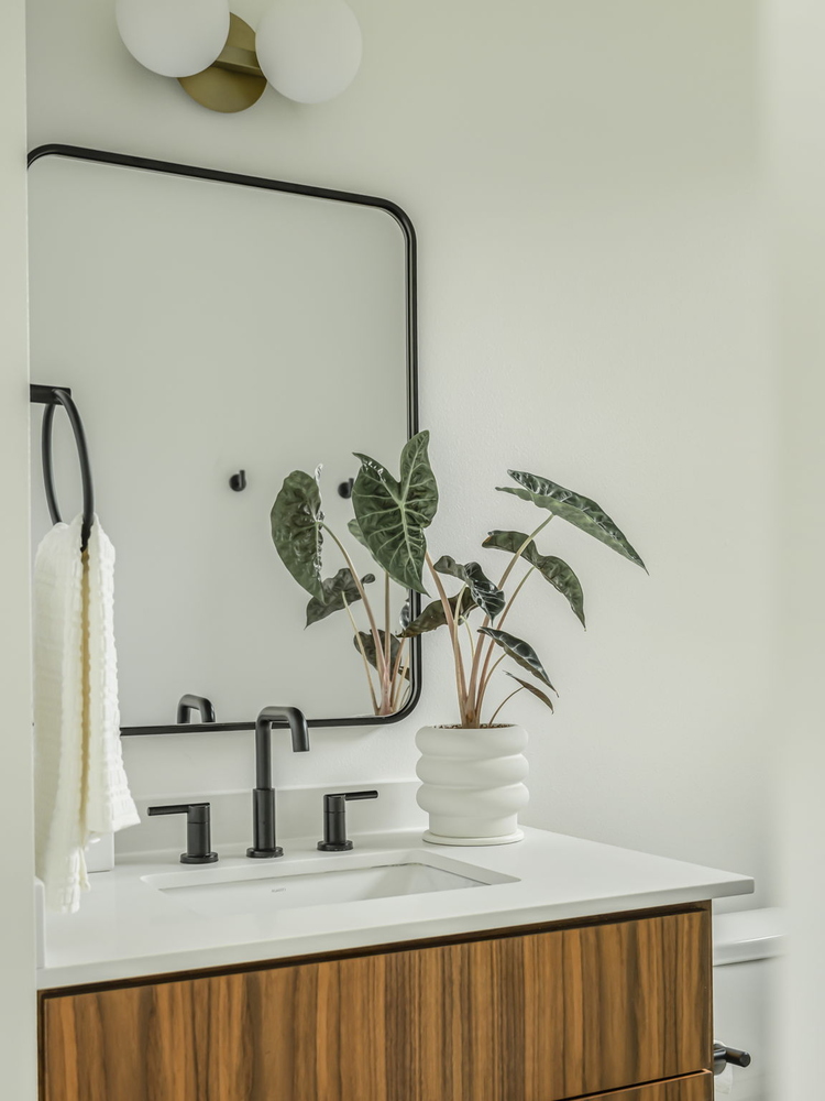 stylish bathroom vanity in RedOven Builds custom home with clean lines and greenery in Rio Grande TX