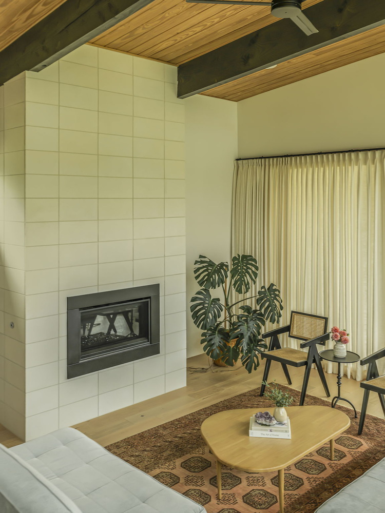 stylish dining room with mid century furniture and fireplace view by RedOven Builds San Juan Dr Rio Grande TX