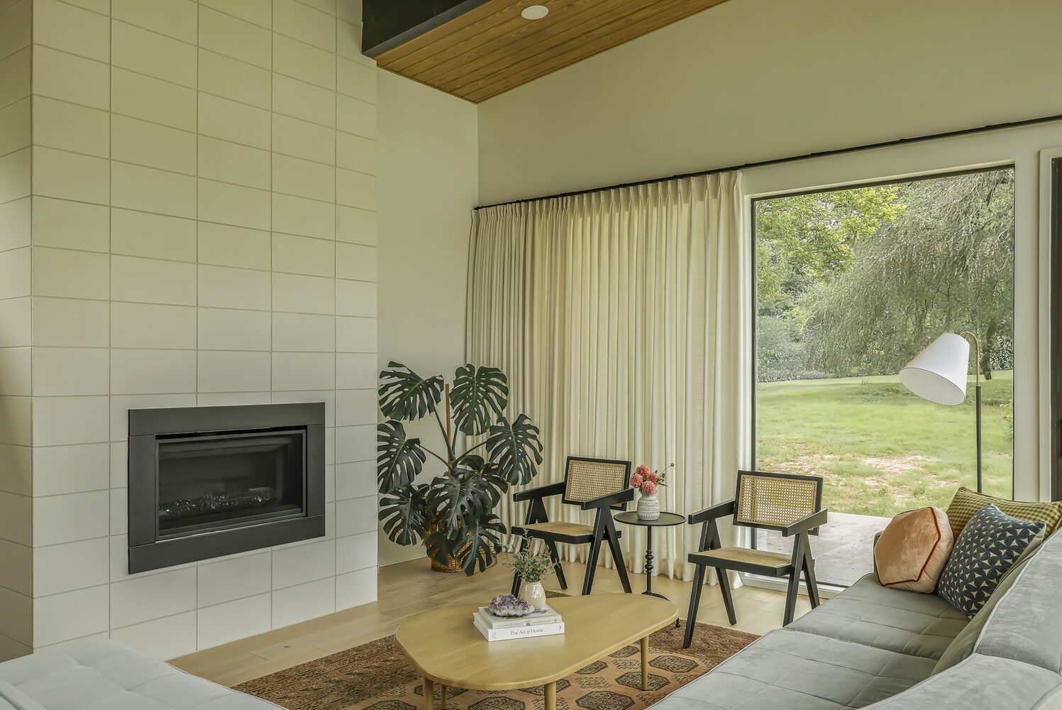 stylish living room with tiled fireplace and large windows in RedOven Builds custom home San Juan Dr Rio Grande TX