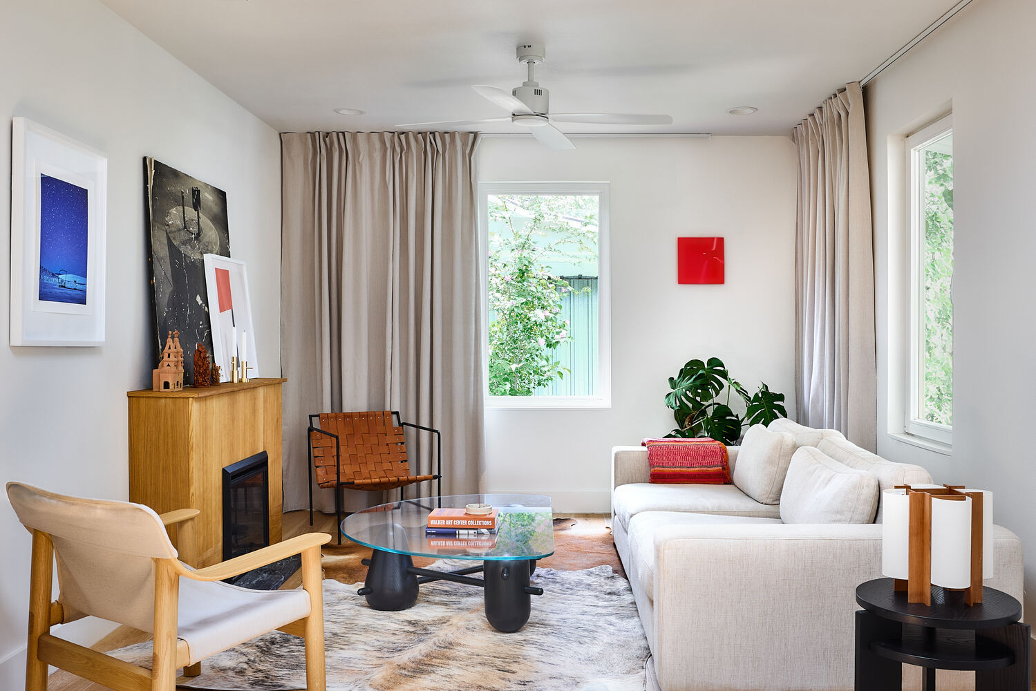bright living room remodel with modern furniture and fireplace by RedOven Builds in Lockhart, TX