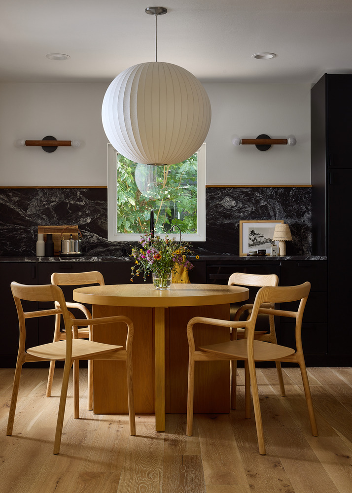 dining area remodel with round wood table and pendant light by RedOven Builds in Lockhart, TX