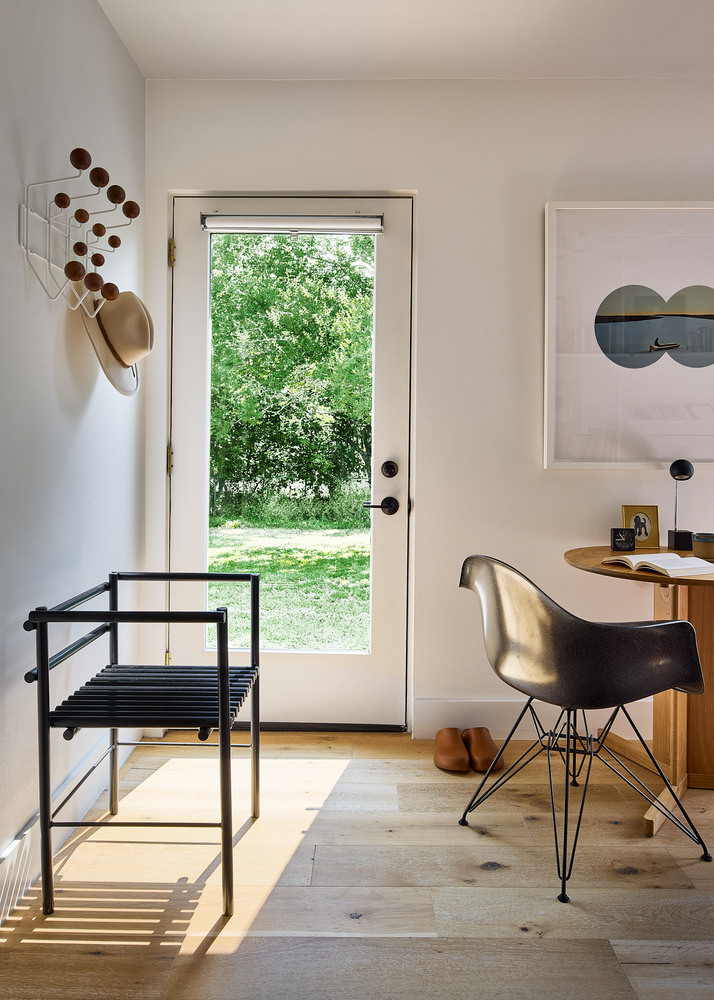 entryway seating area with glass door and natural light by RedOven Builds in Lockhart, TX