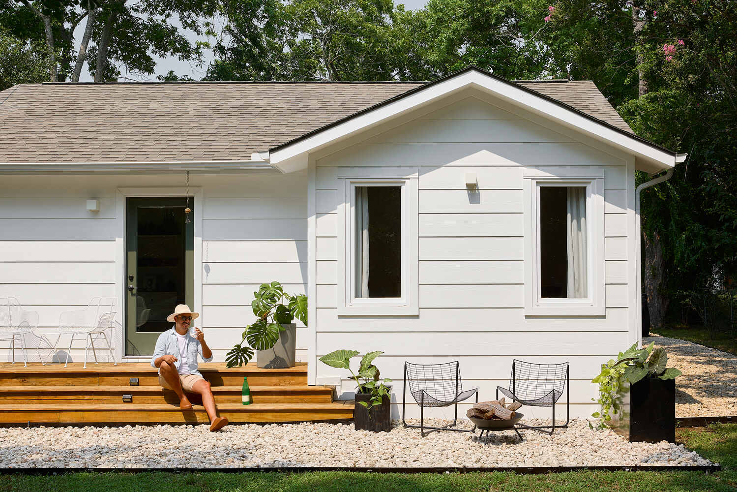 exterior patio remodel with wood deck and landscaping by RedOven Builds in Lockhart, TX