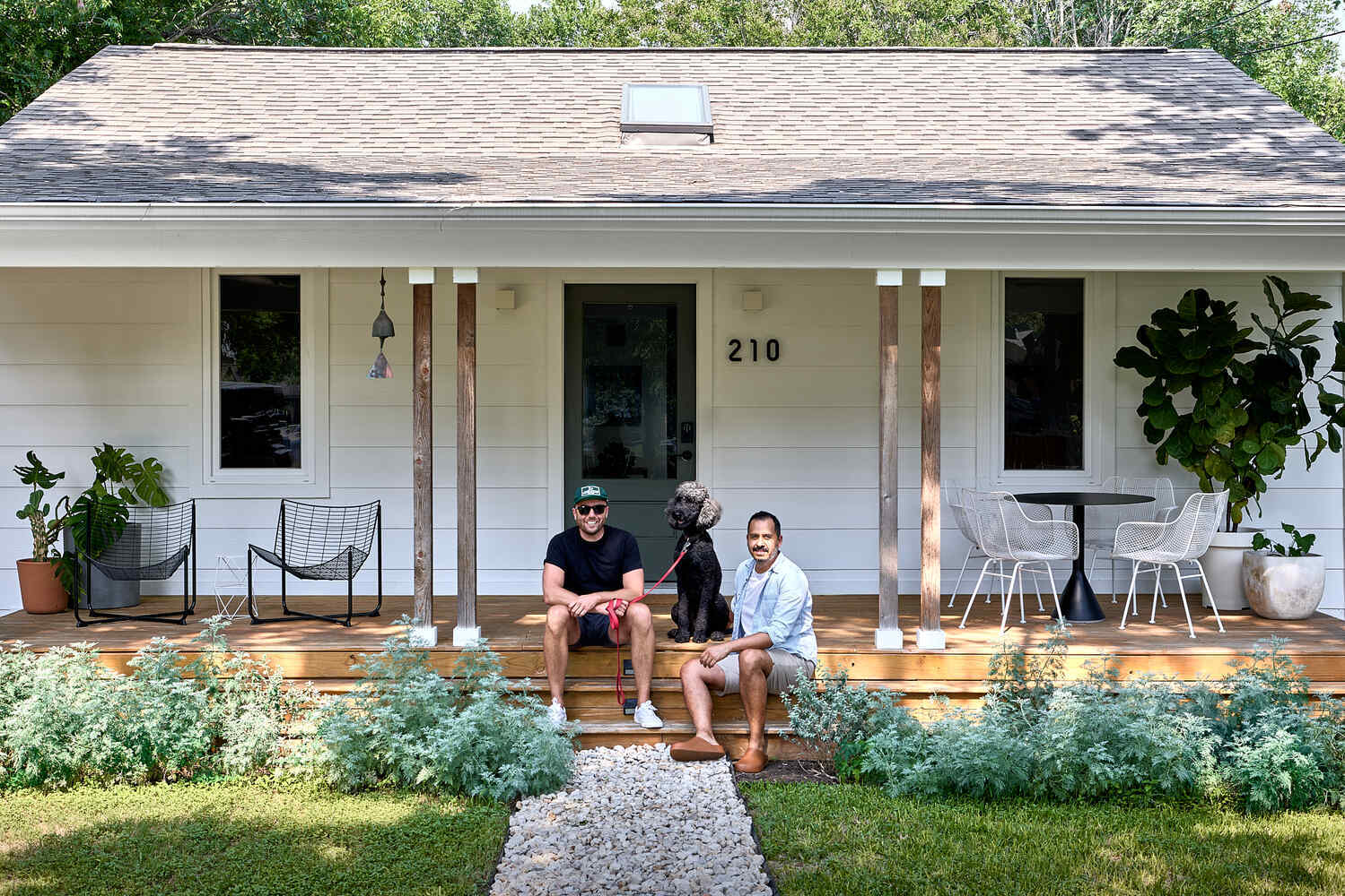 front porch with homeowners and dog at remodeled home by RedOven Builds in Lockhart, TX