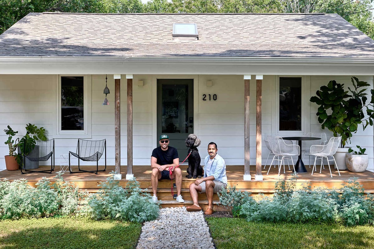 front porch with homeowners and dog at remodeled home by RedOven Builds in Lockhart, TX