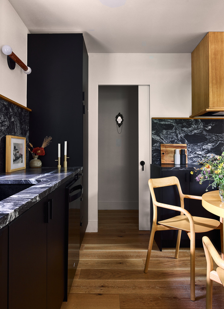 hallway with modern decor and wood flooring from remodel by RedOven Builds in Lockhart, TX